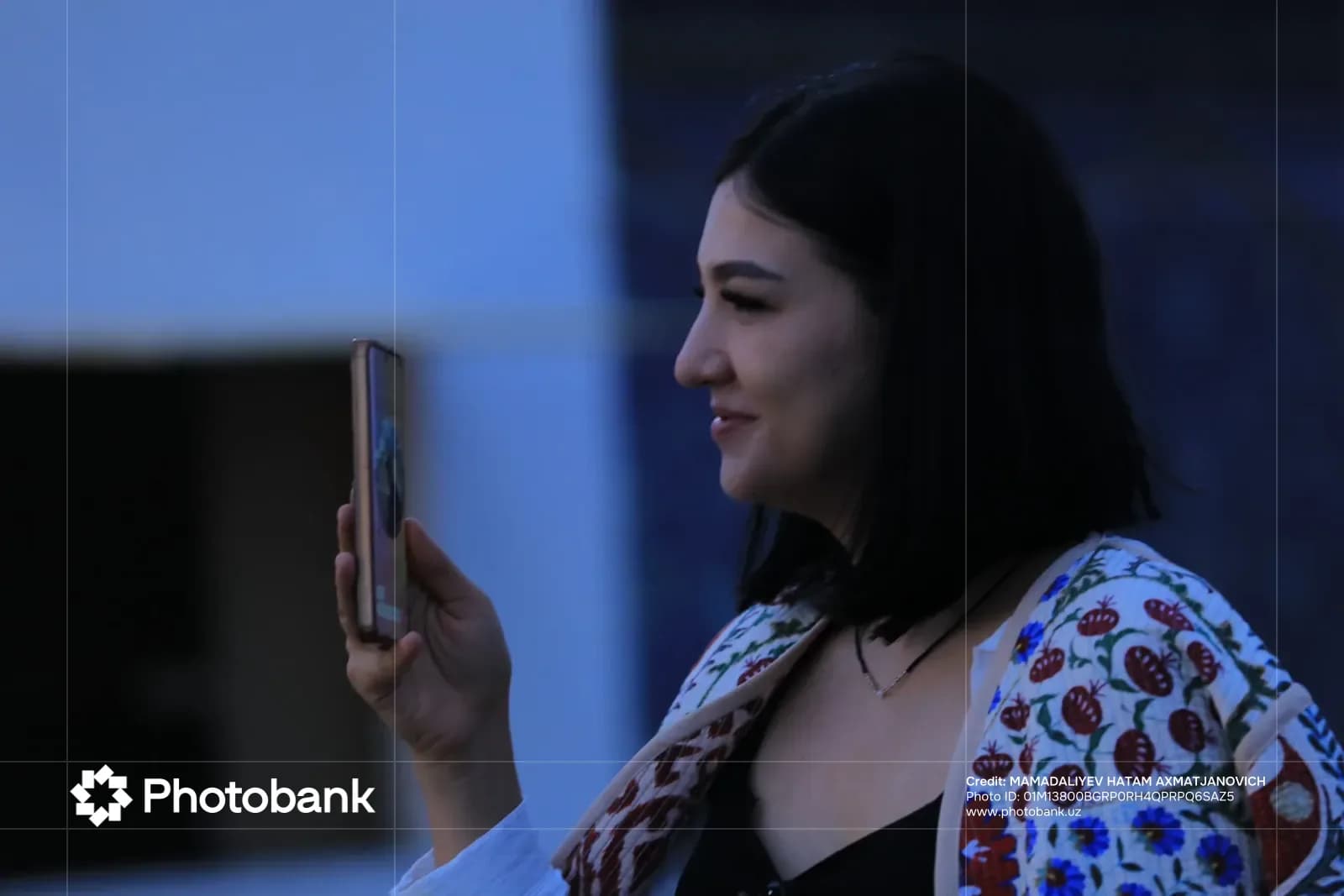Person holding a smartphone outdoors
