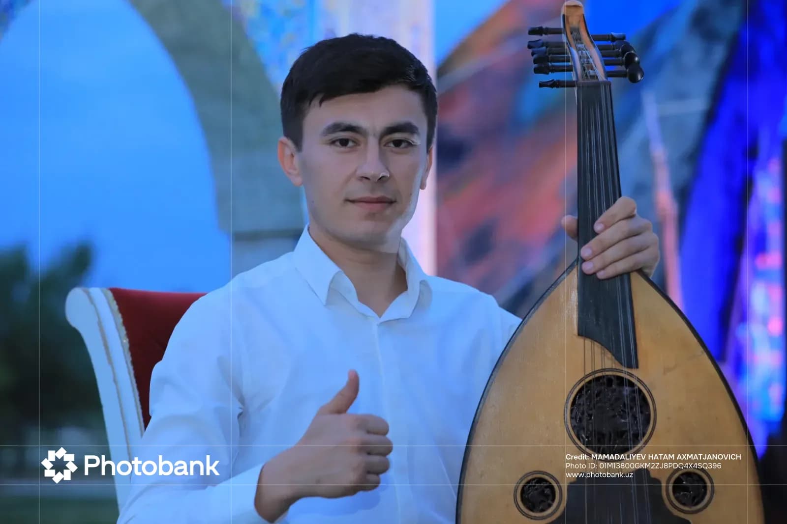 Portrait of a man holding a musical instrument