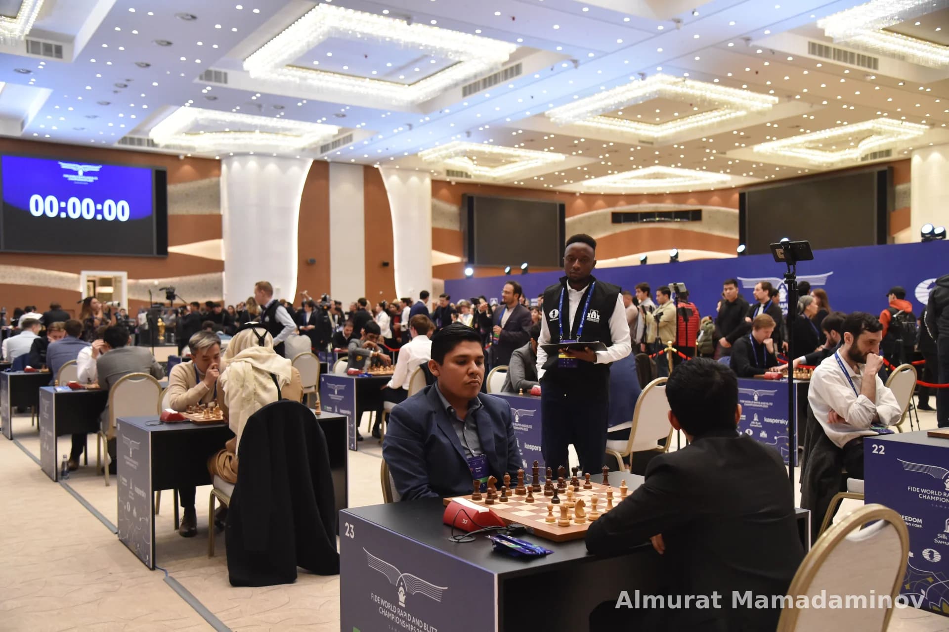 People playing chess in a tournament hall