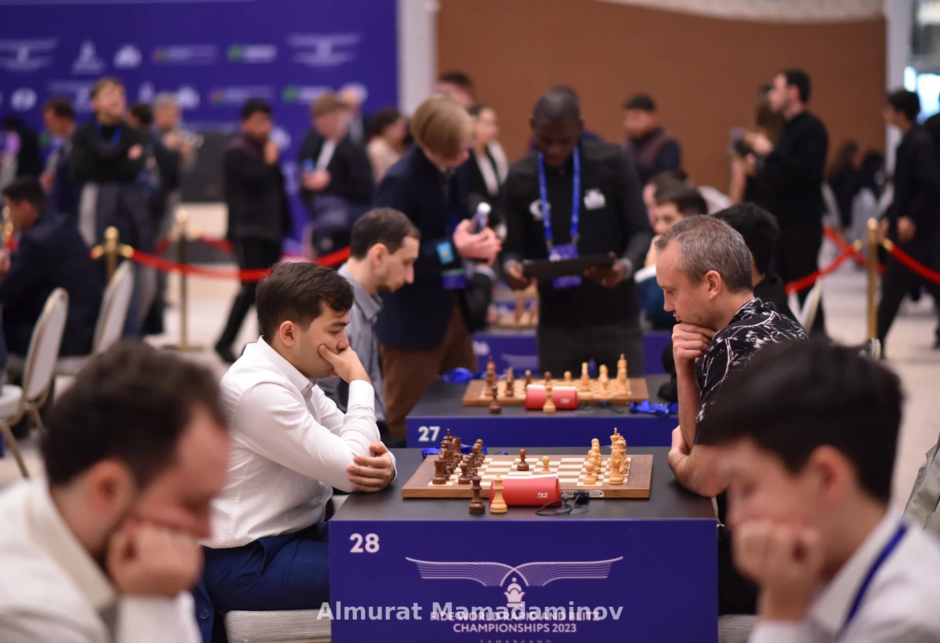 People playing chess at a competition table