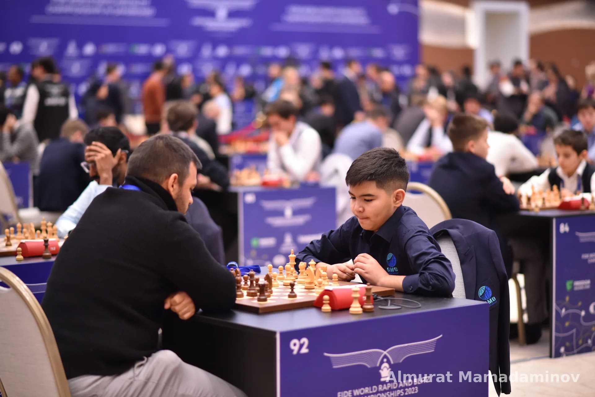 People playing chess at a competition table