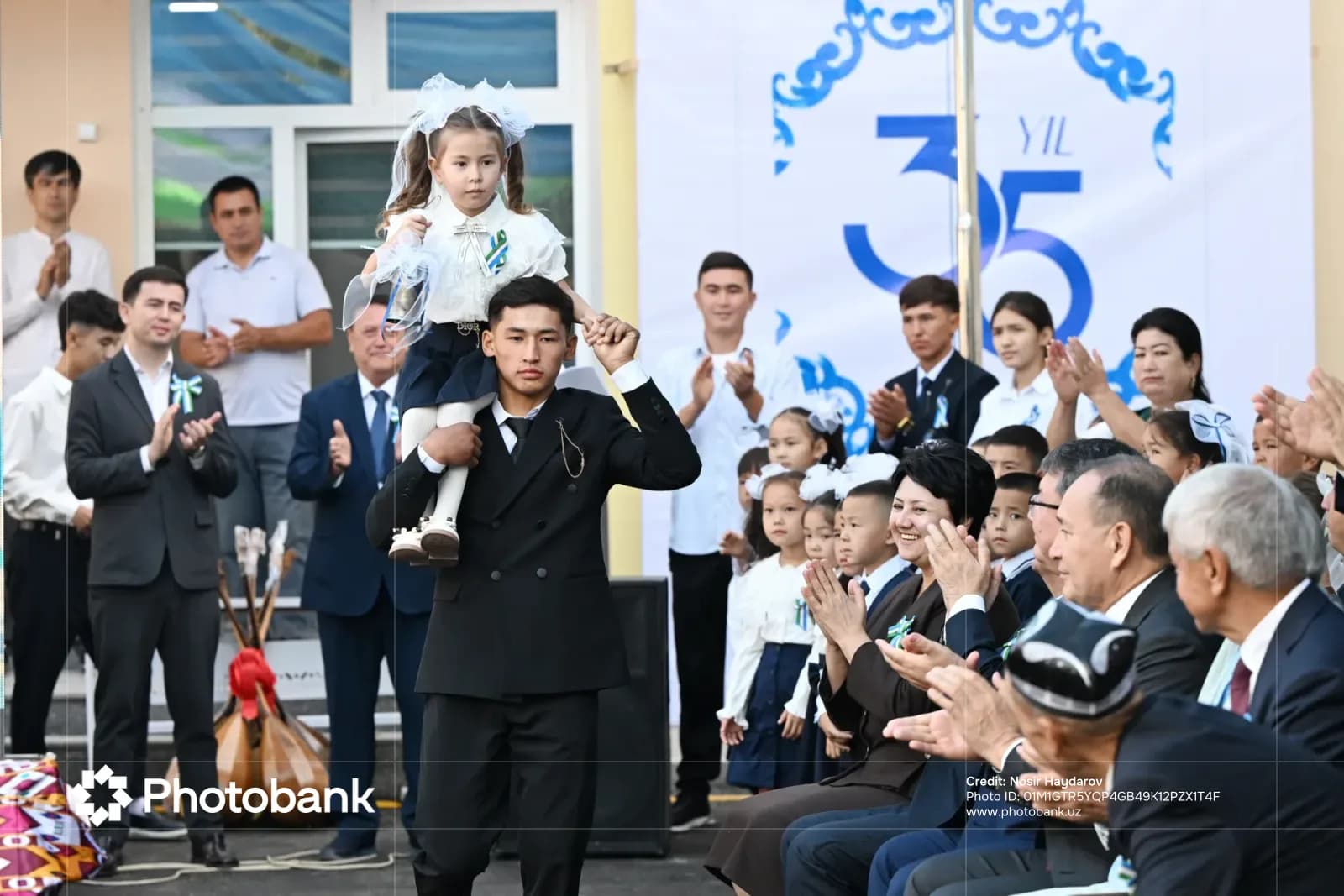 Young girl on shoulders during celebration
