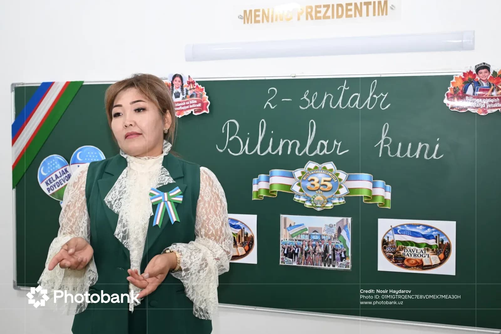 Woman standing in front of a chalkboard with writing