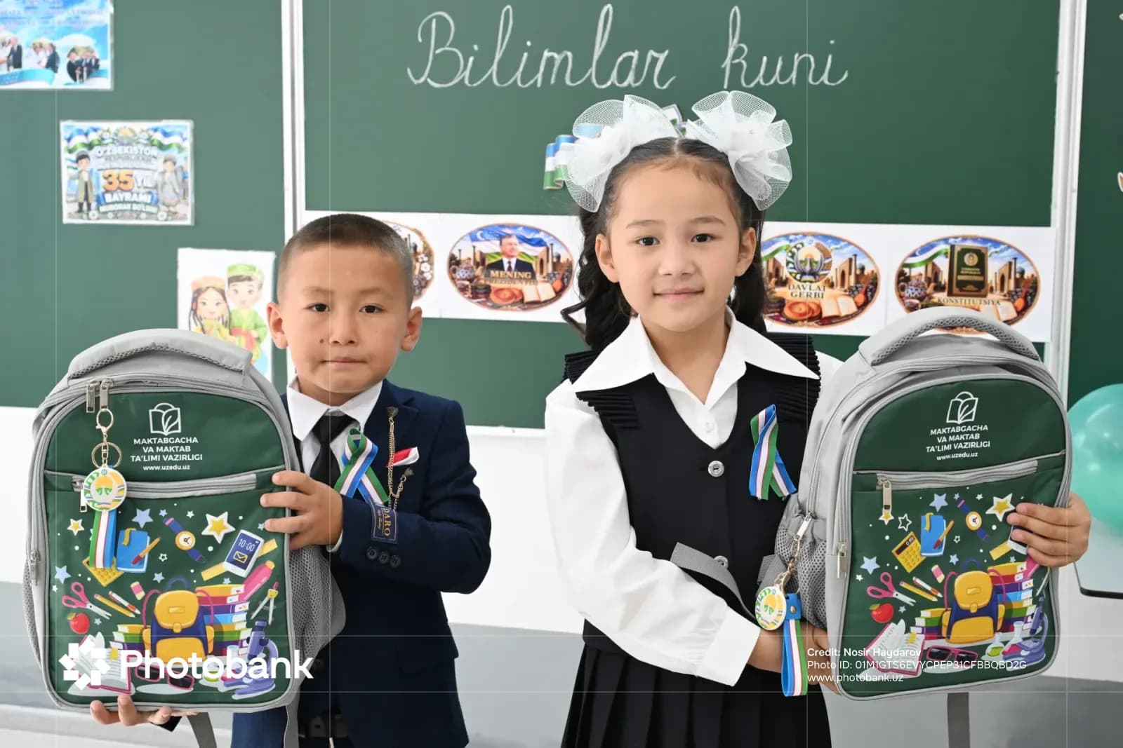 Children holding school backpacks in a classroom