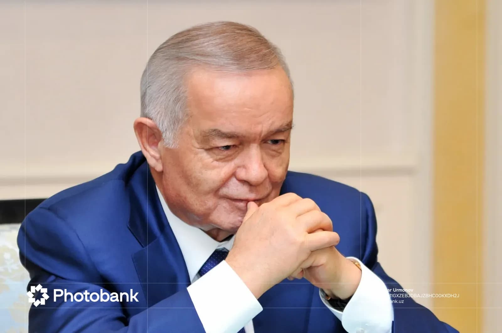 Portrait of a senior man sitting with clasped hands