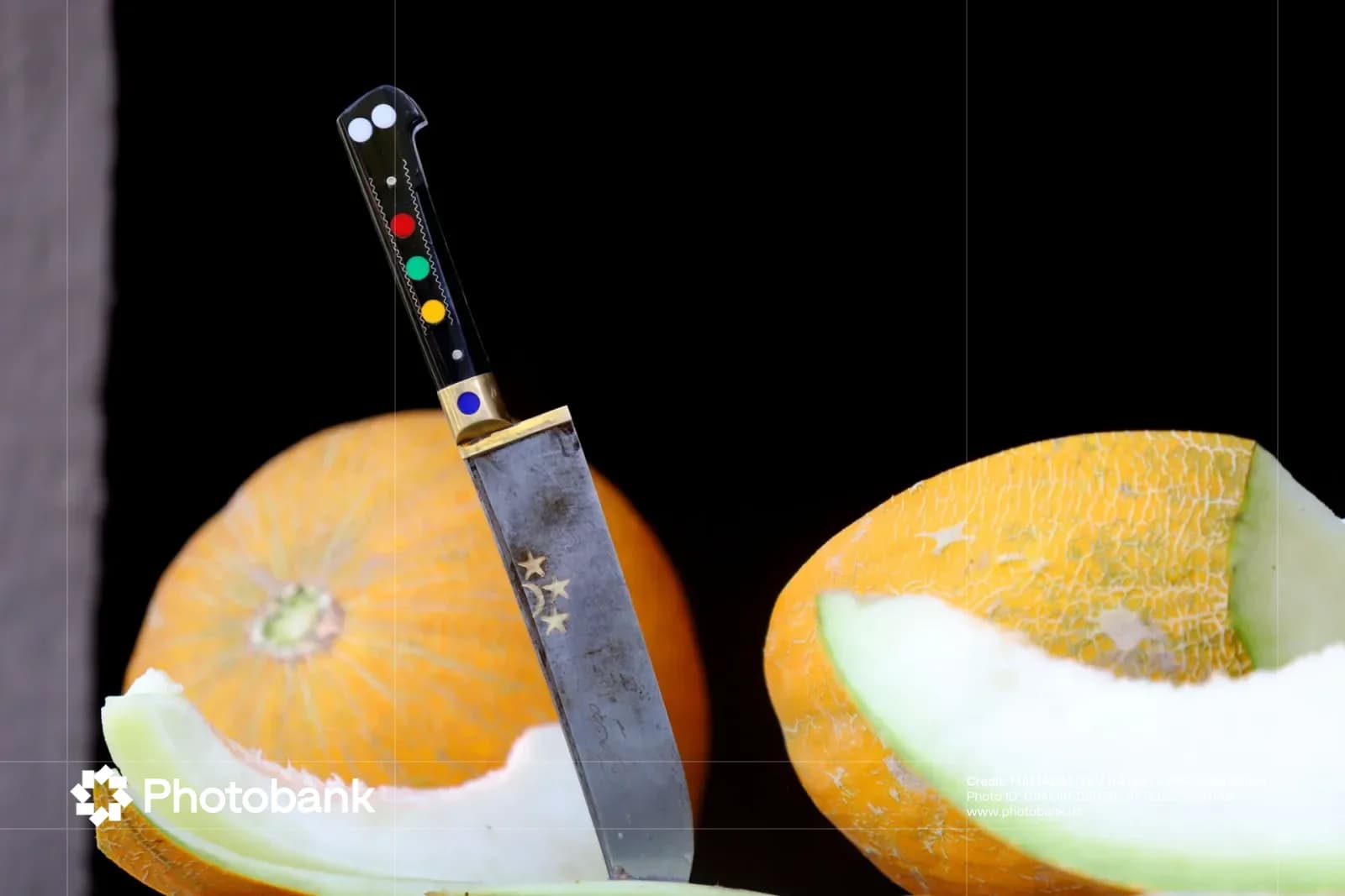 Traditional knife placed among sliced and whole melons