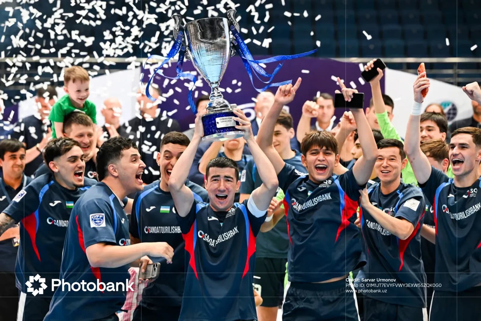 Athletes celebrating with a trophy