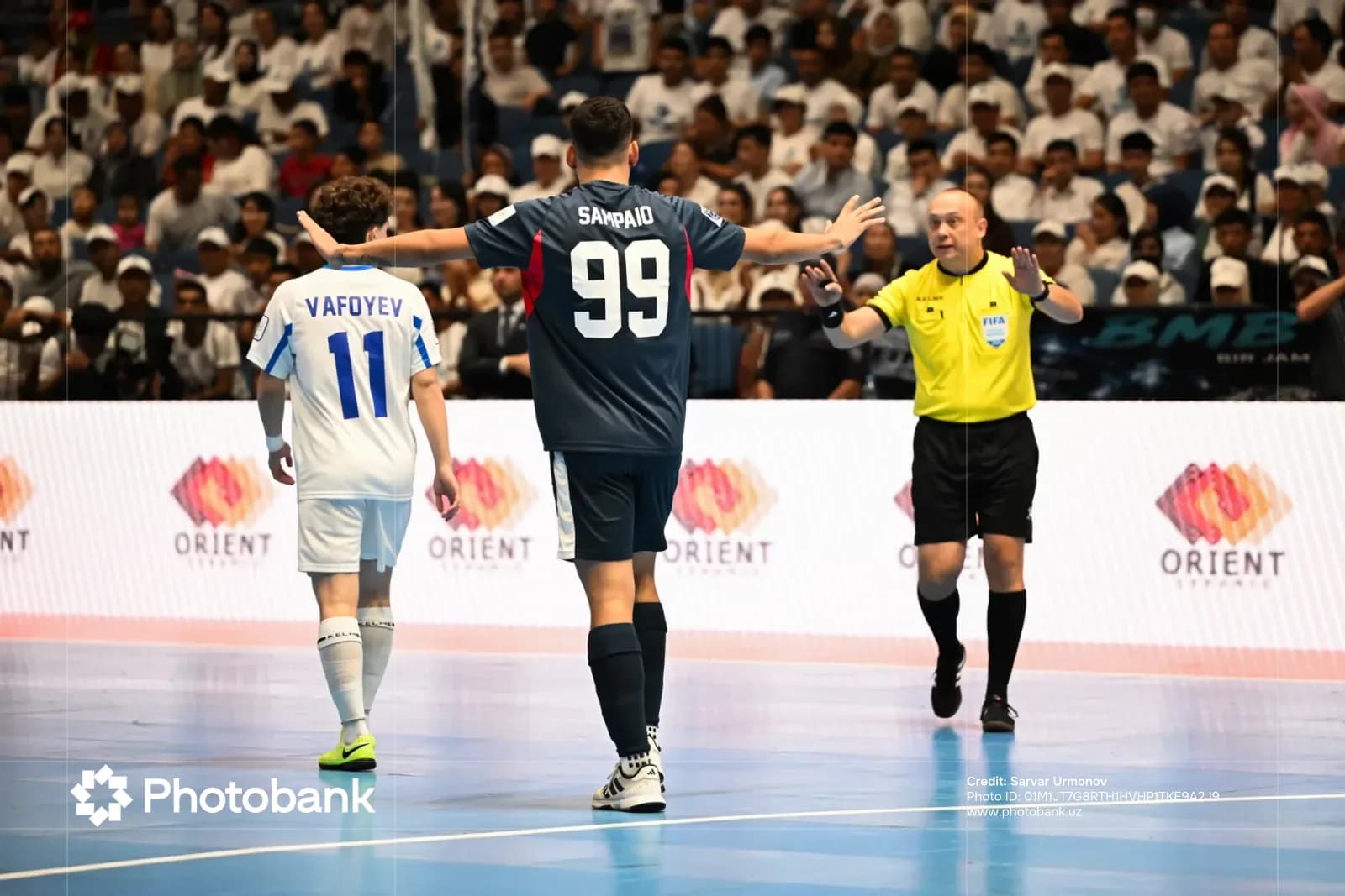 Players and referee on indoor court