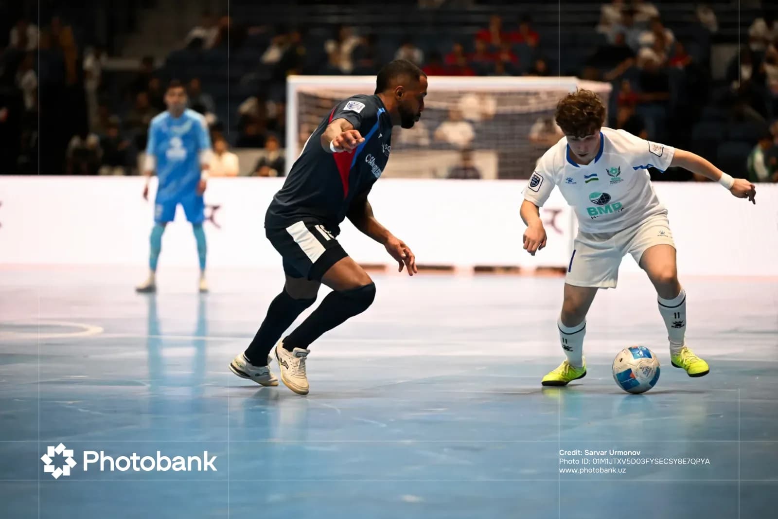 Futsal players compete for the ball during an indoor match