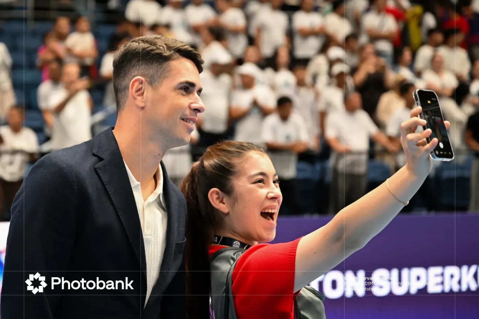 People taking a selfie together at an indoor venue