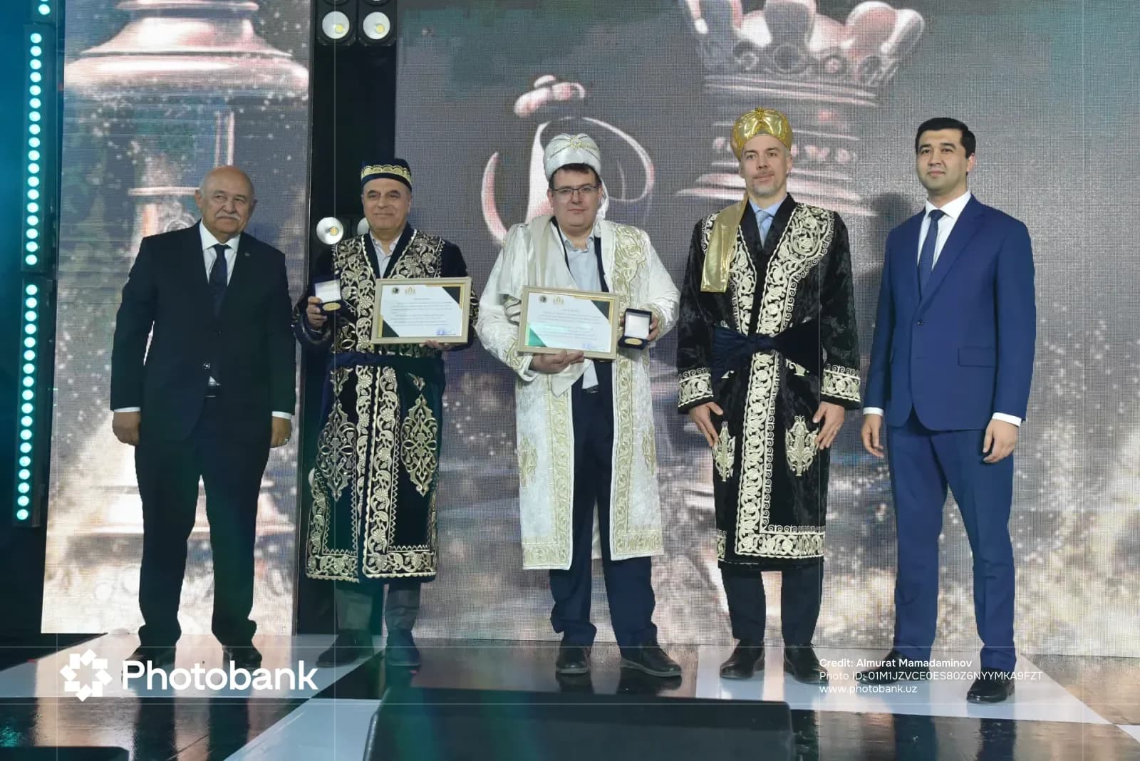 Групповое фото мужчин, получающих сертификаты и награды на сцене