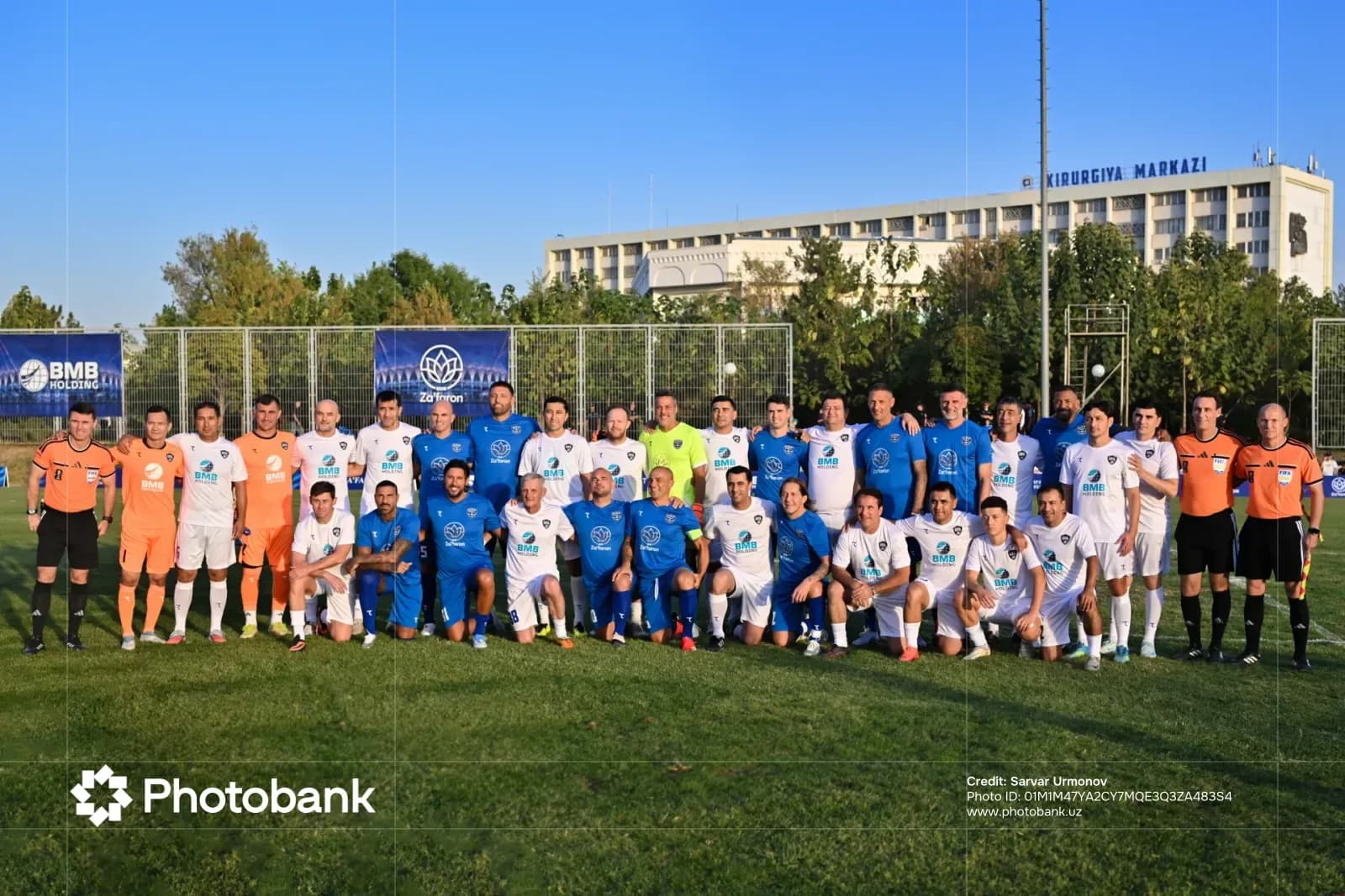 Group photo of football teams on a field