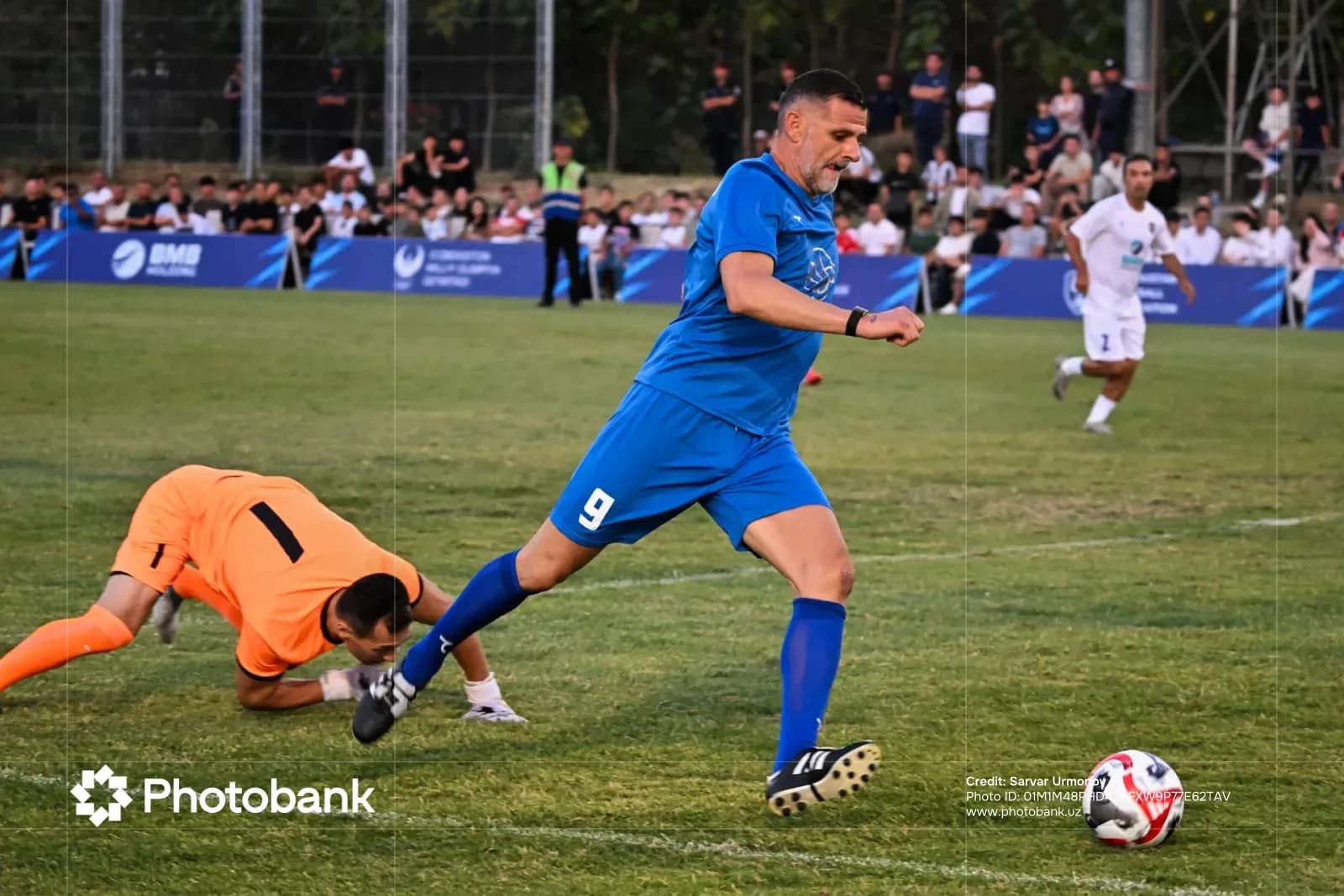 Football players competing during a match on a grass field