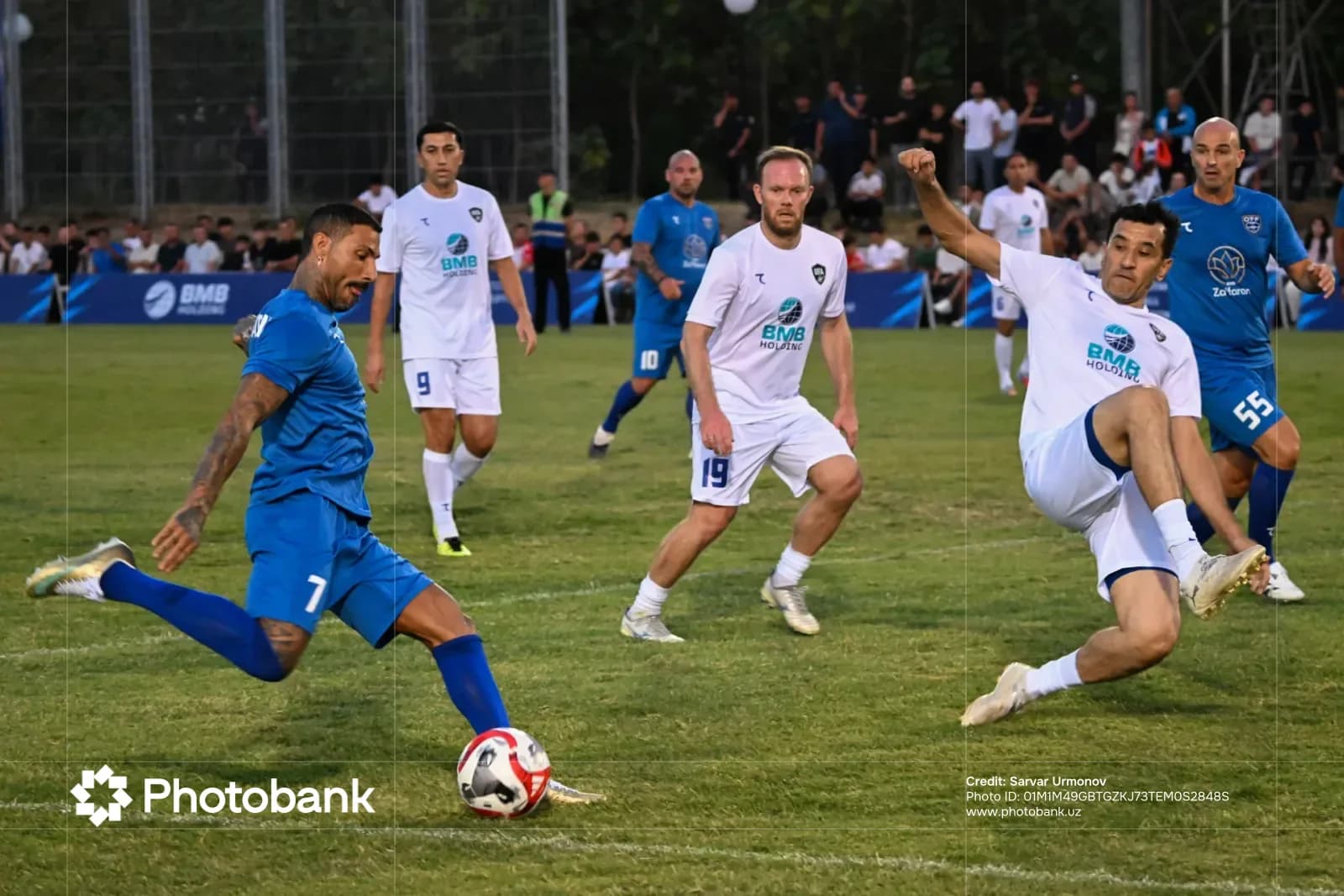 Football players competing during a match on a grass field