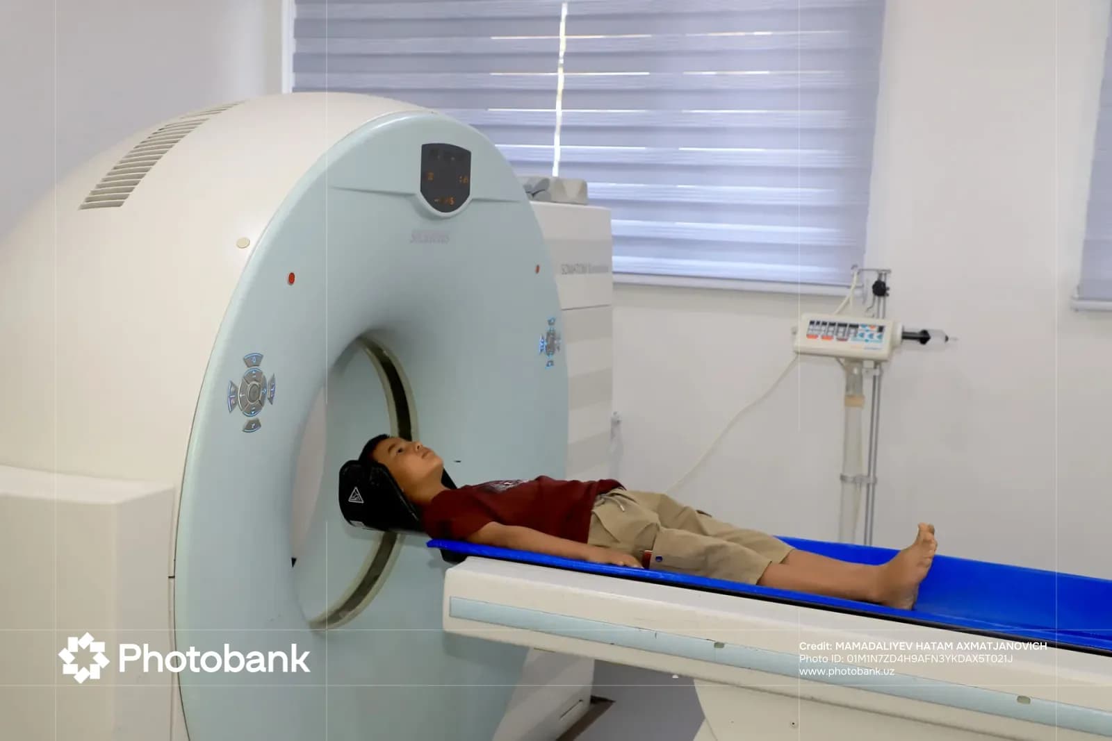 Young person undergoing medical imaging scan on a CT scanner