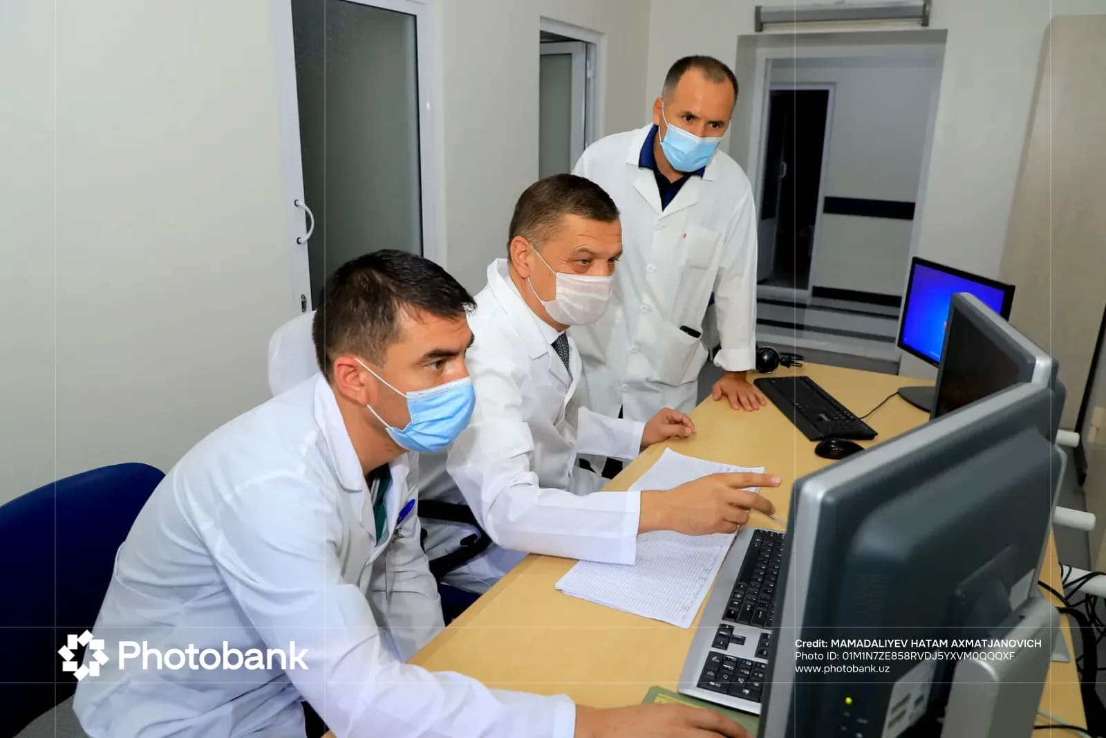 People working in a room with computers