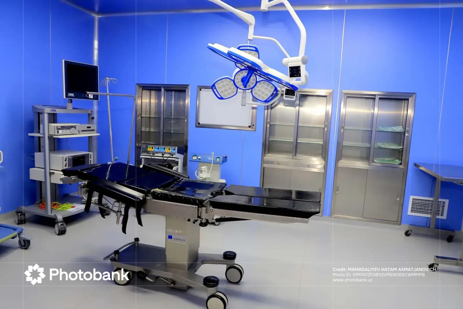 Modern operating room with medical equipment and surgical table