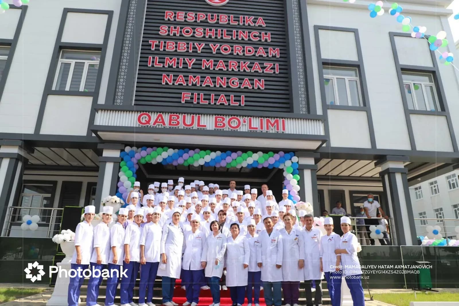 Medical staff gathered in front of a medical facility building