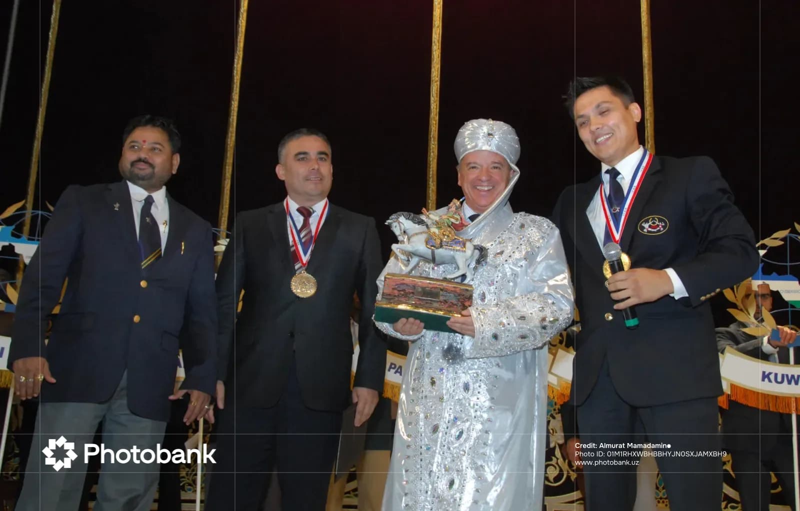 Group of men posing together during an awards ceremony
