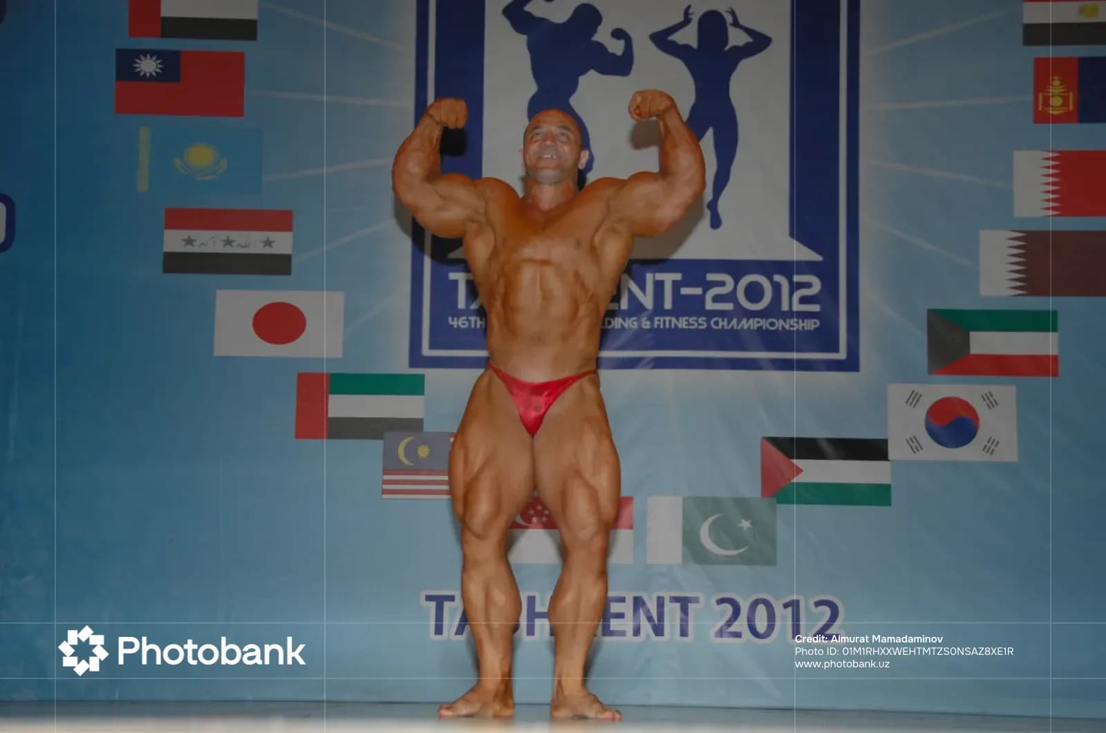 Male bodybuilder poses on stage during a competition