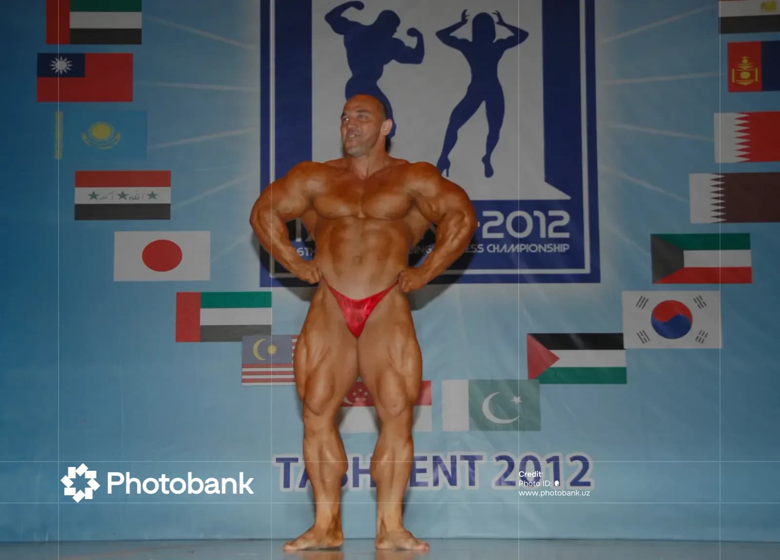 Bodybuilder poses on stage at competition