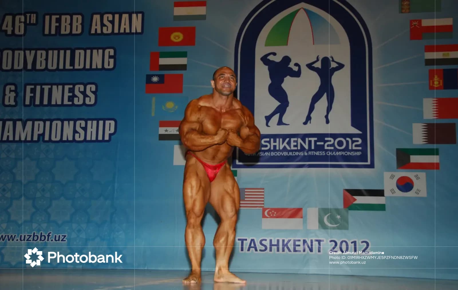 Bodybuilder posing on stage at a fitness championship