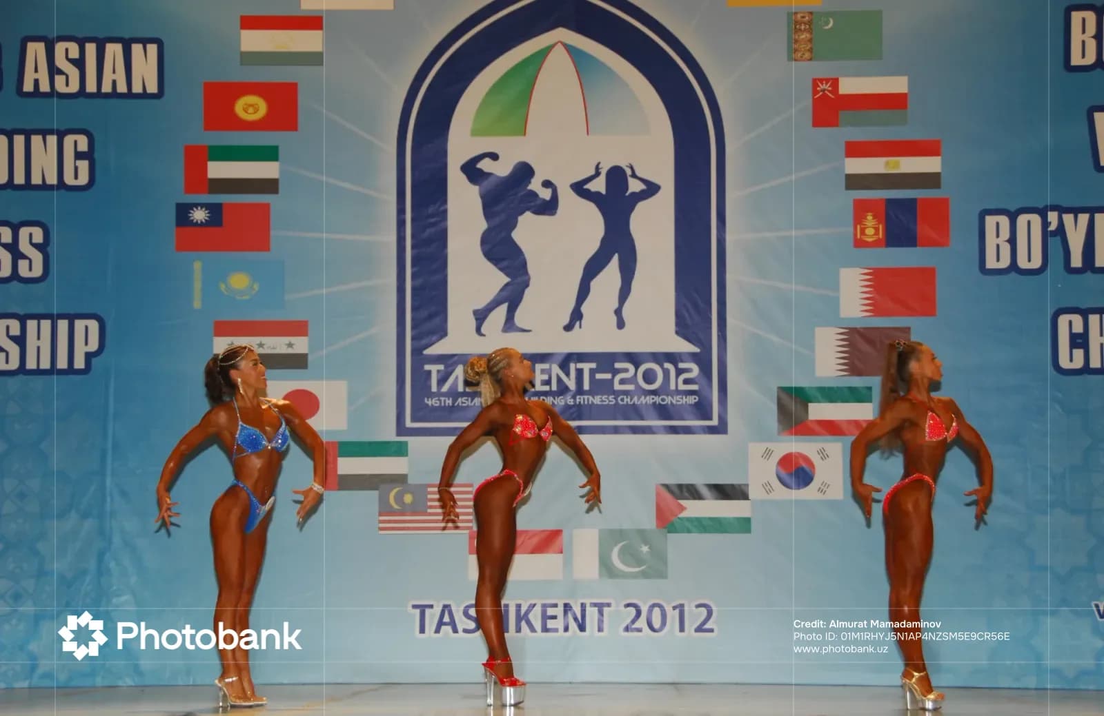 Female athletes posing on stage at a bodybuilding competition