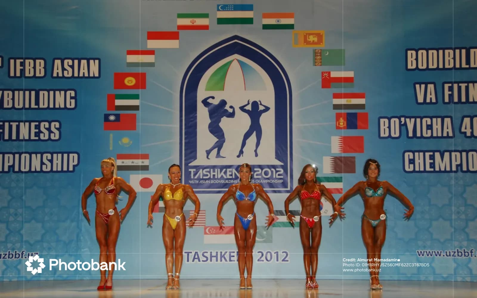 Female athletes posing on stage at a bodybuilding championship