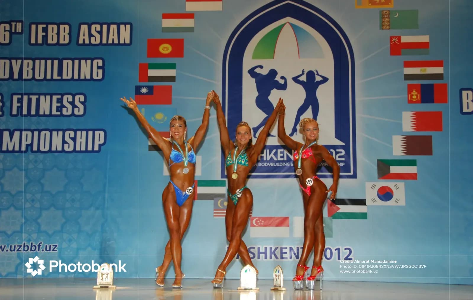 Athletes posing on stage during a sport competition