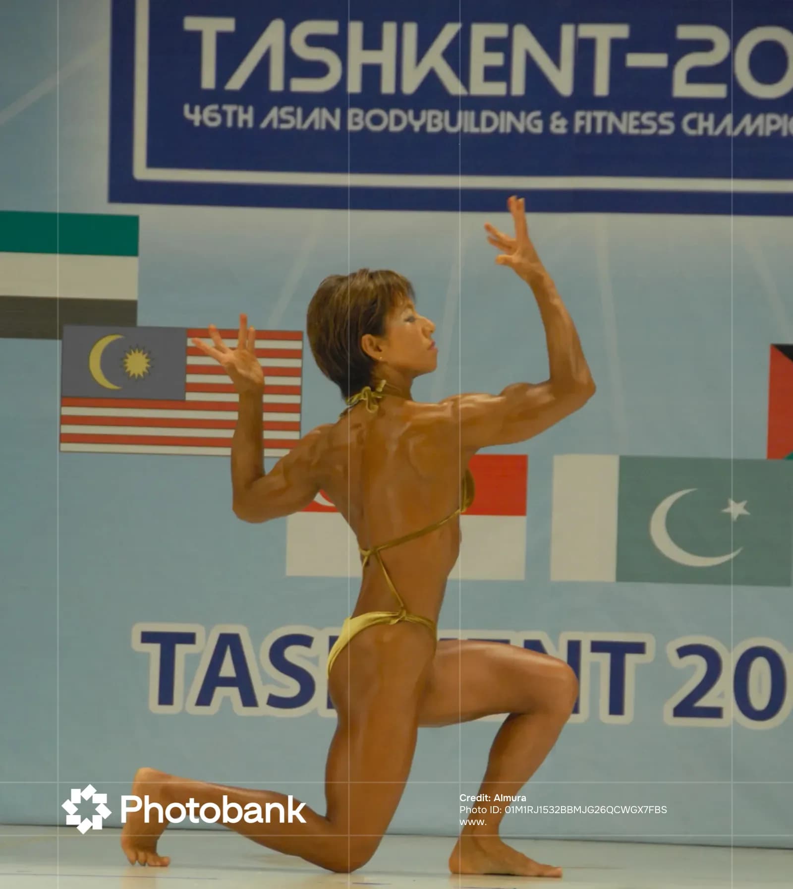 Athlete poses on stage during competition