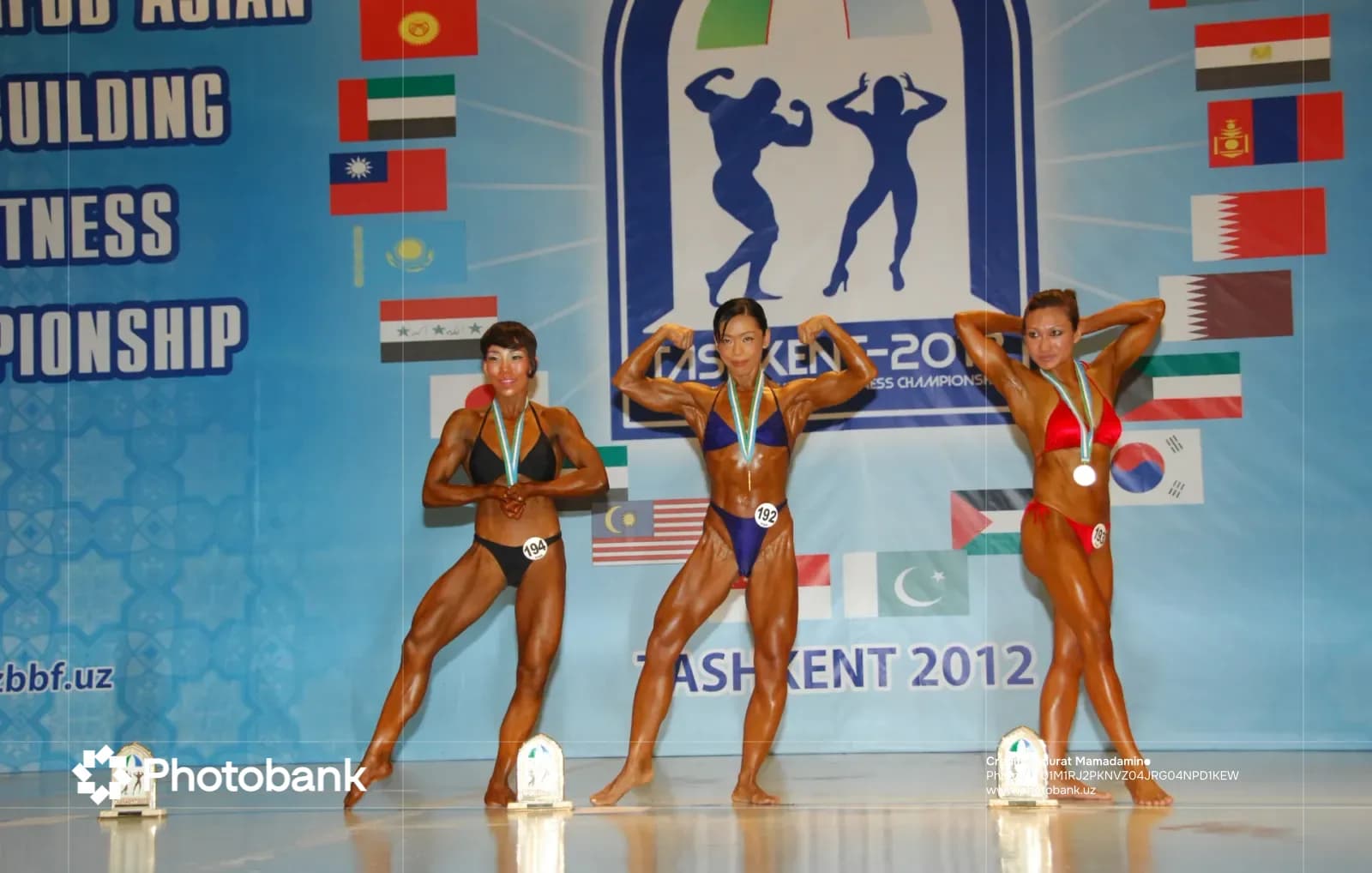 Female athletes posing on stage during a bodybuilding championship