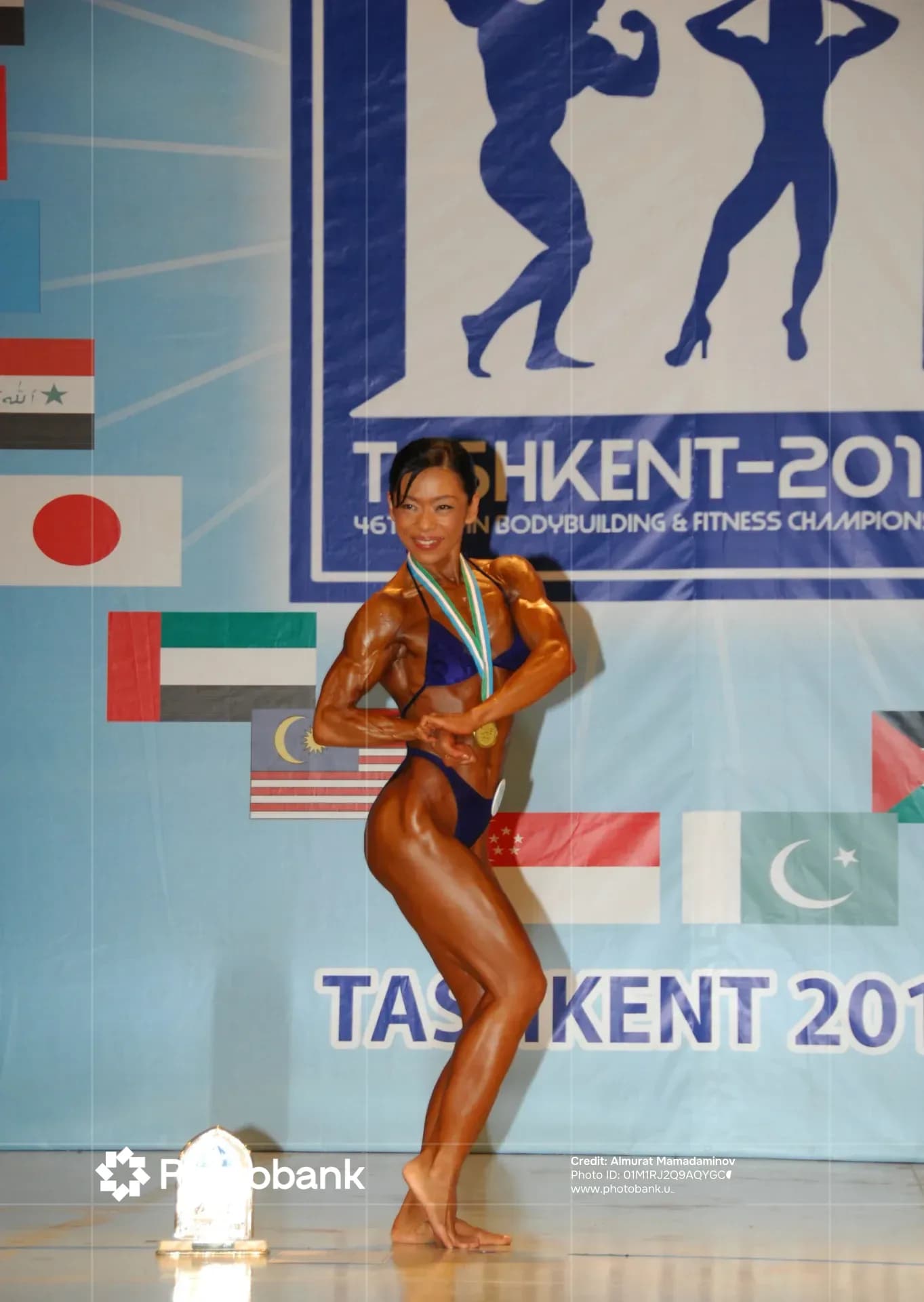 Athlete poses with a medal at a sports competition