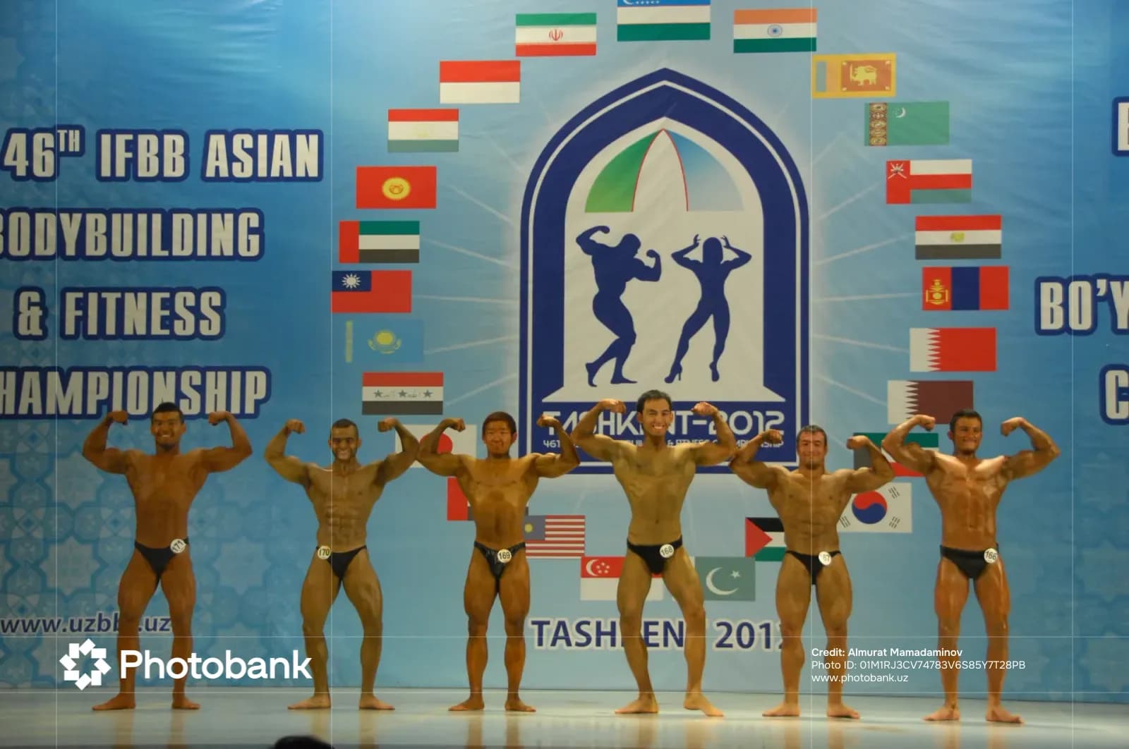 Bodybuilders posing on stage during a competition