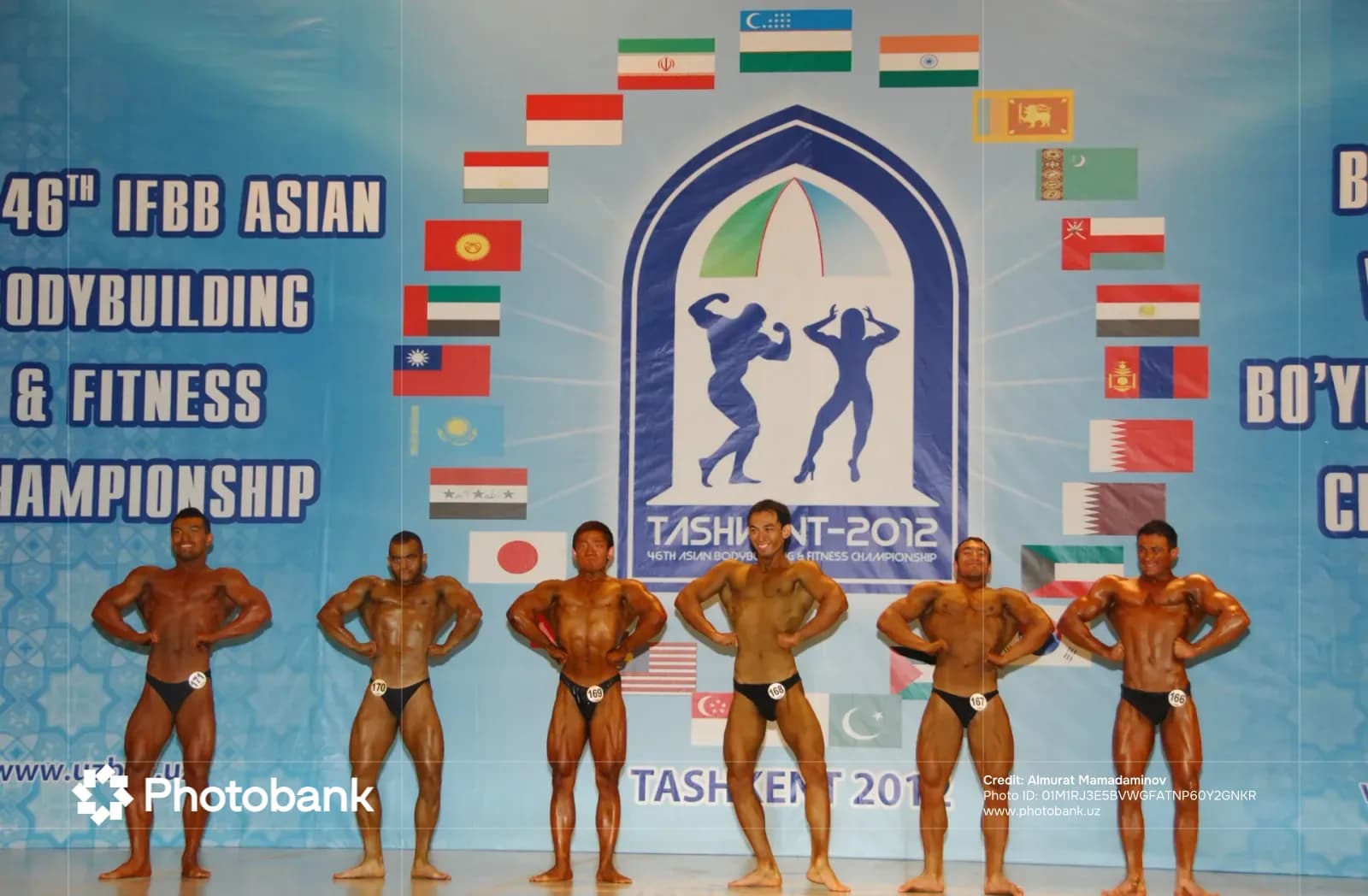 Bodybuilders posing on stage at a championship event