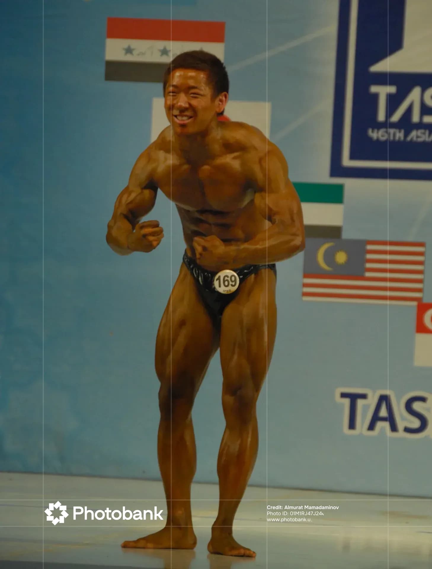 Bodybuilder flexing muscles on stage