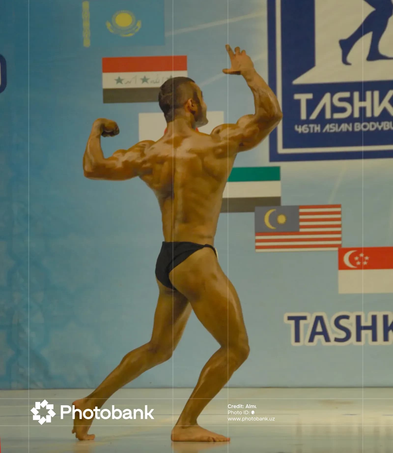 Athlete posing on stage during a bodybuilding competition