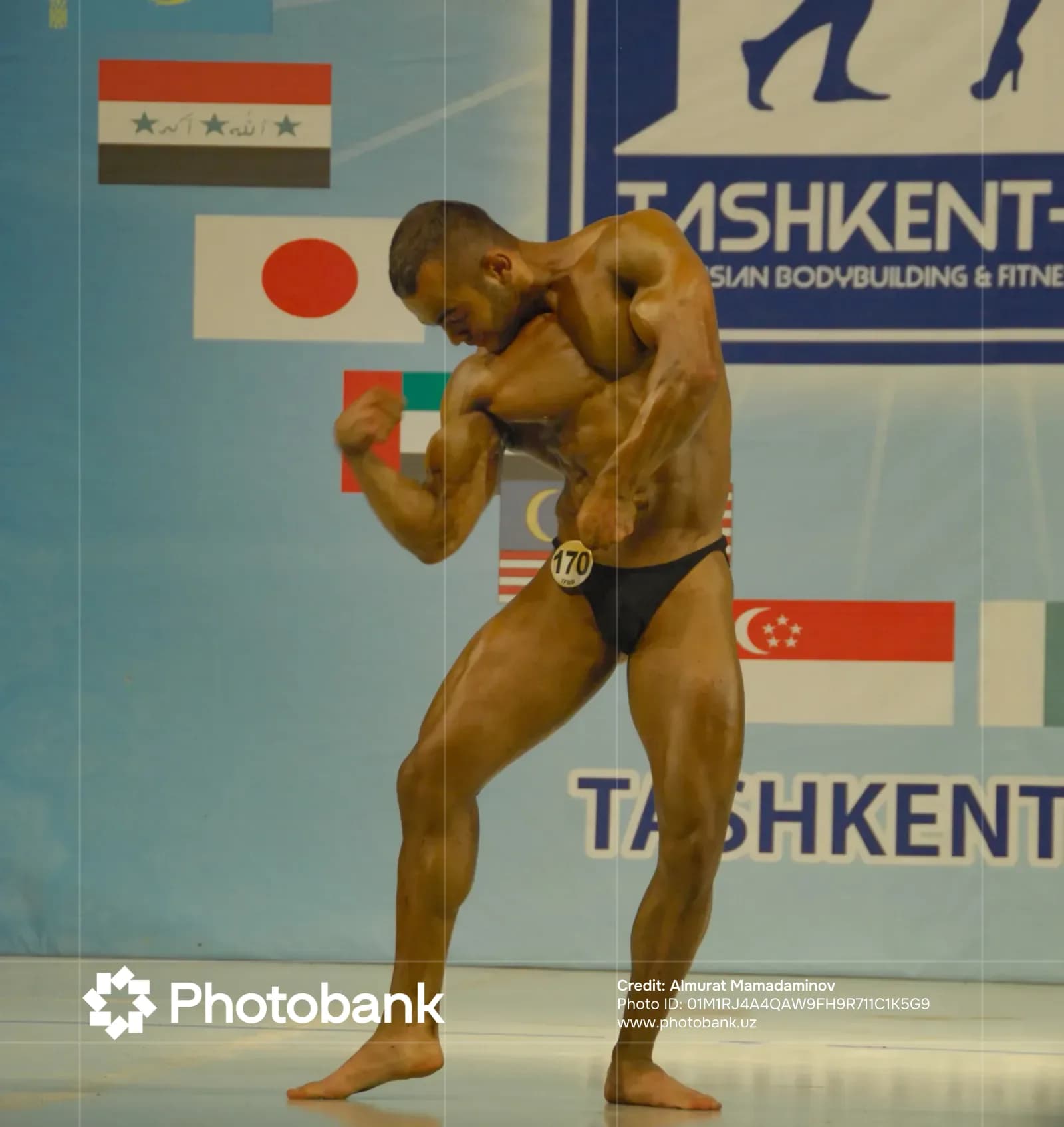 Athlete posing on stage during competition