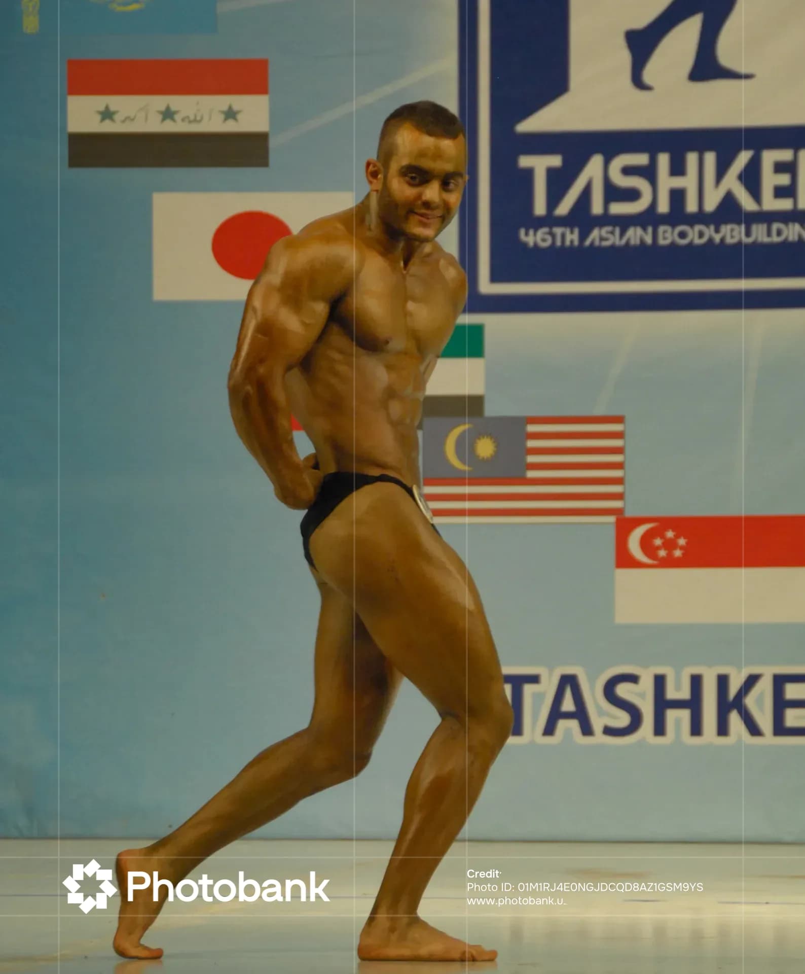 Bodybuilder posing during a sports competition