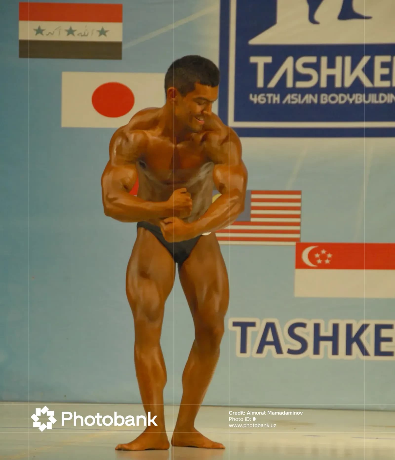 Athlete posing on stage during a bodybuilding competition