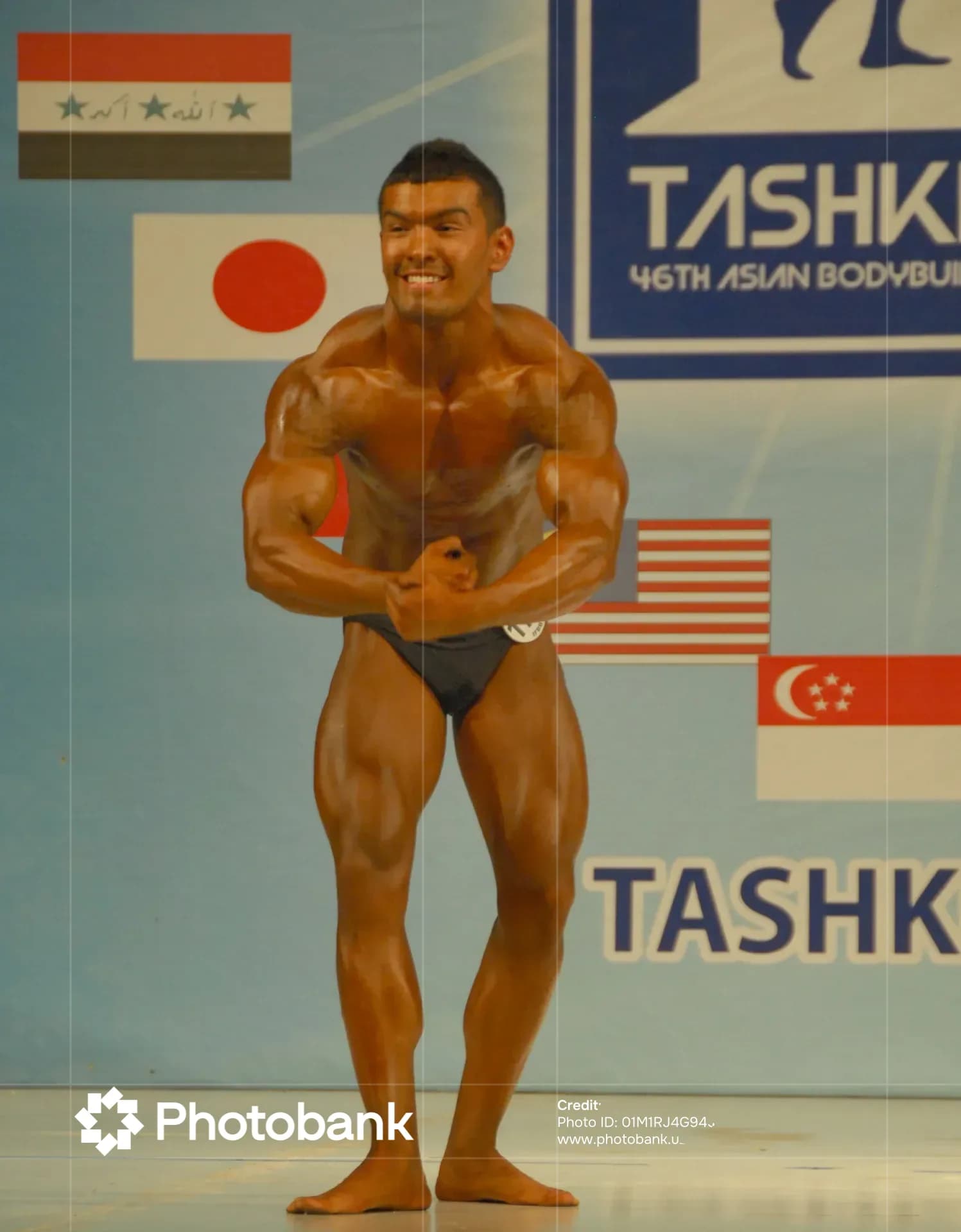 Athlete poses on stage during a sports competition