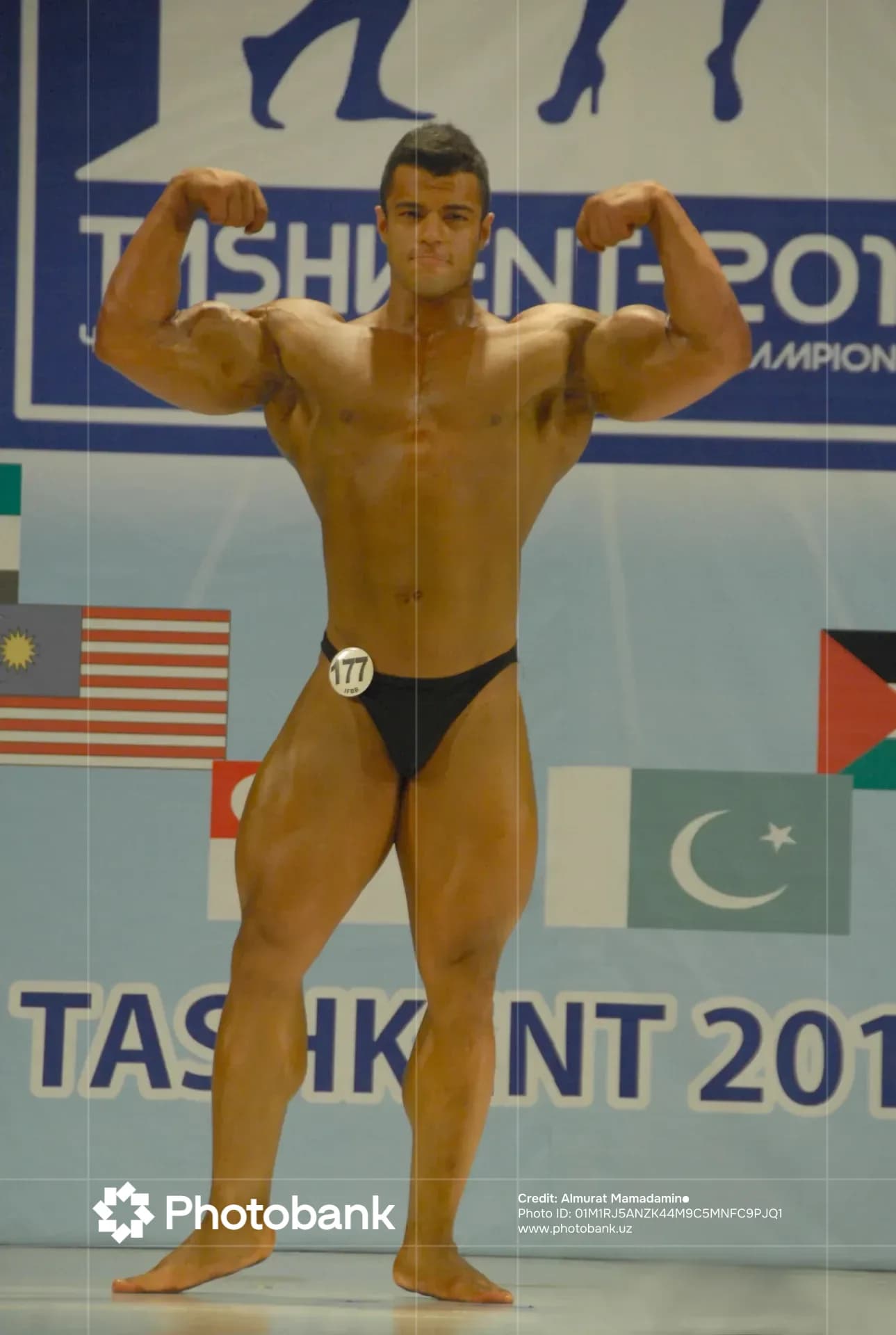 Bodybuilder posing during a sports competition