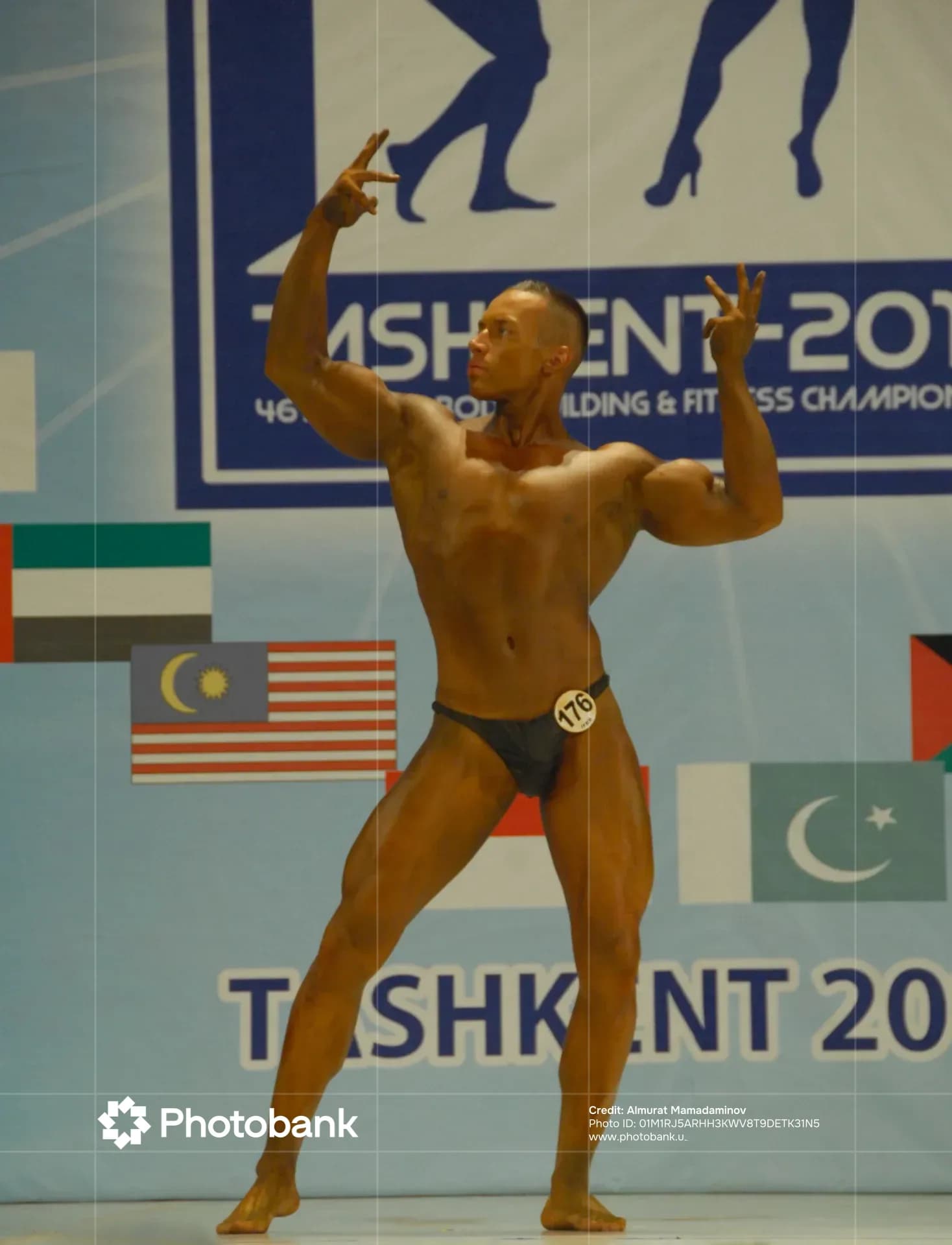 Athlete poses on stage during competition