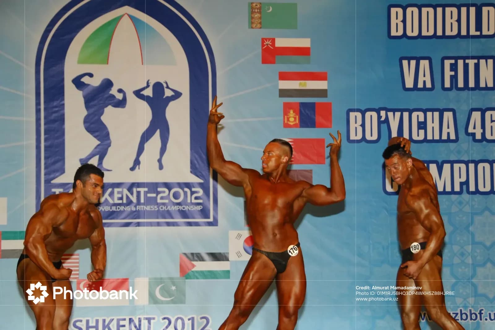 Bodybuilders posing on stage during a competition