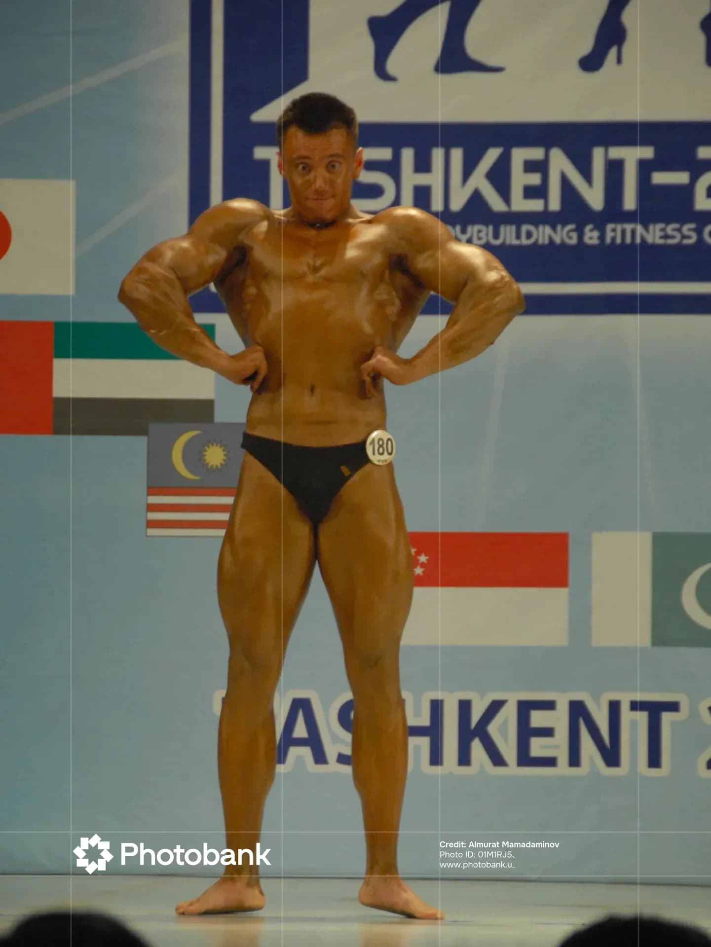Bodybuilder posing on stage during a competition