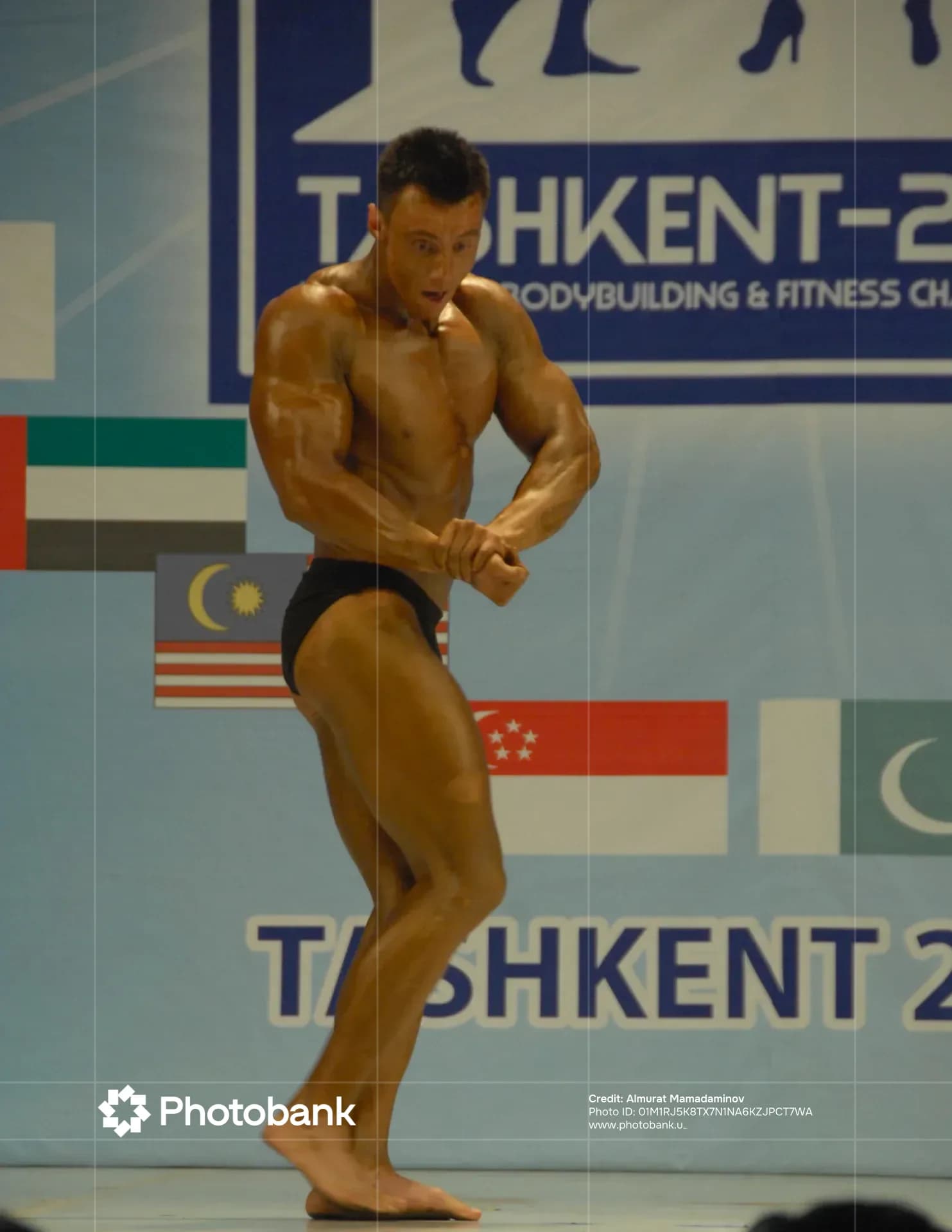 Bodybuilder posing during a sports competition