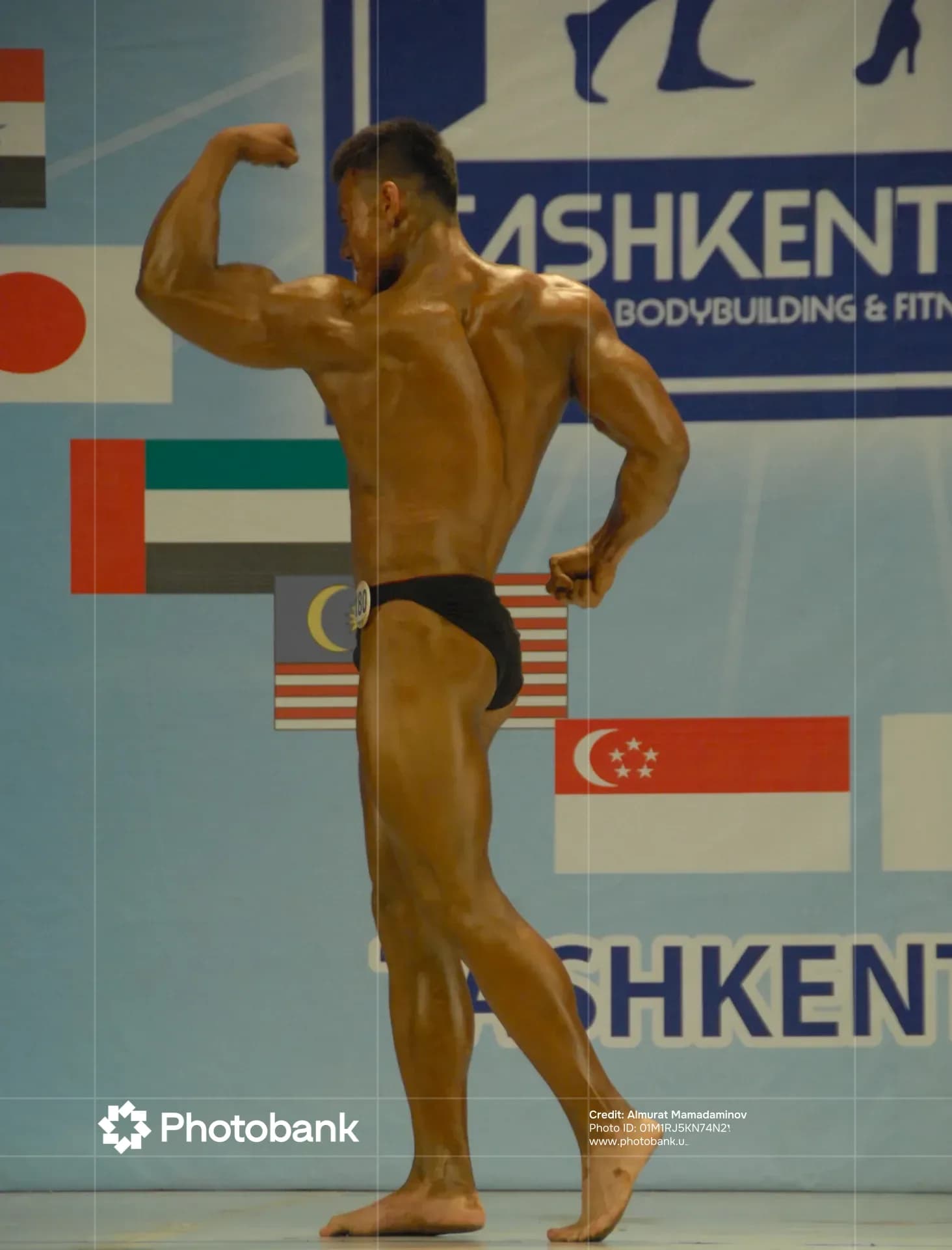 Bodybuilder posing during a sports competition