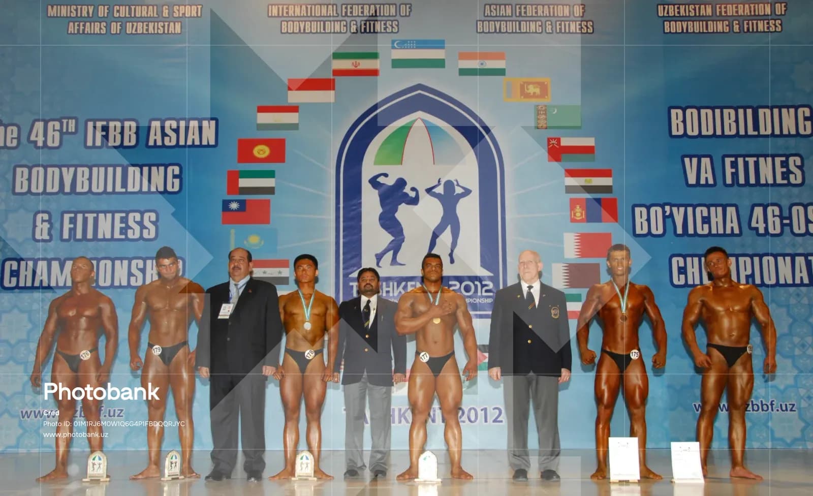 Group of male bodybuilders posing on stage during a championship event