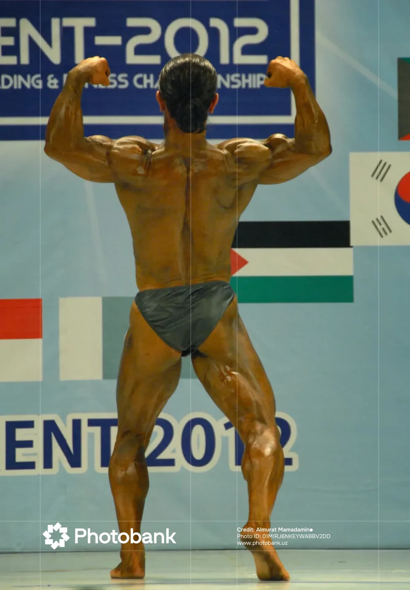 Athlete posing on stage during a bodybuilding competition