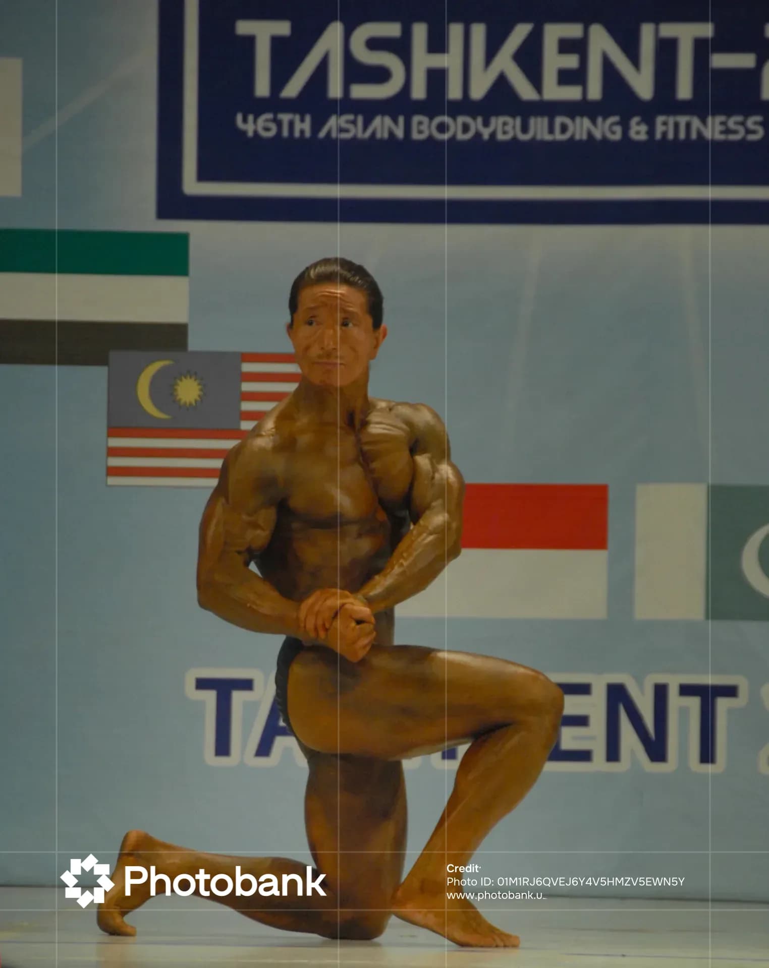 Athlete poses on stage during sports competition