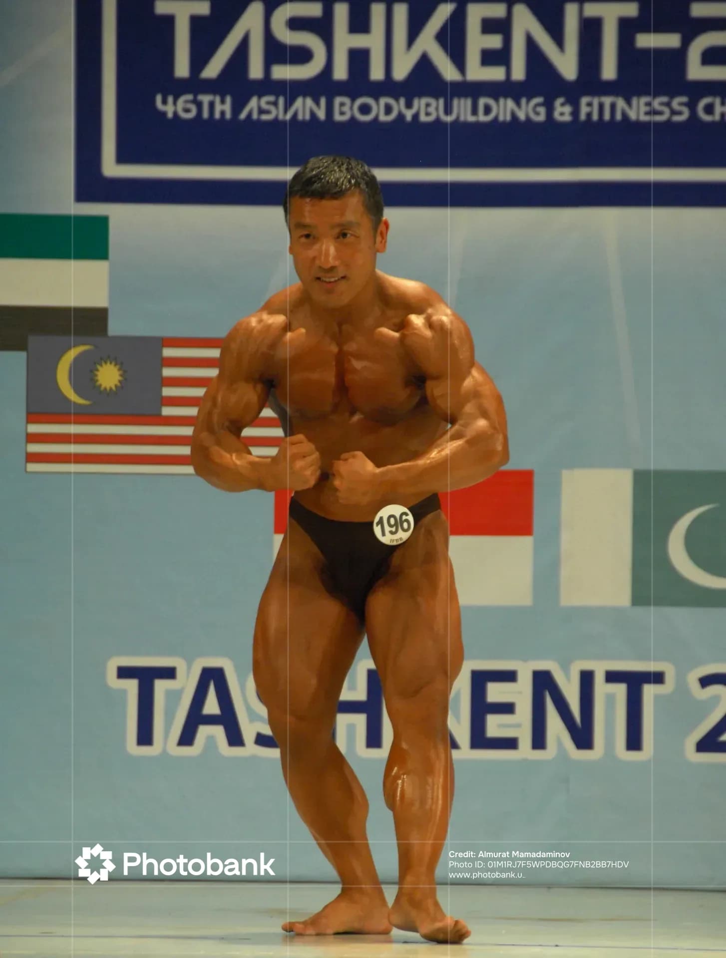 Bodybuilder posing during a sports competition